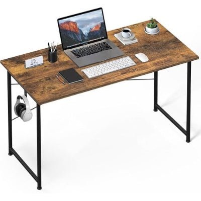 Wooden desk with laptop, keyboard, and other items on a white background