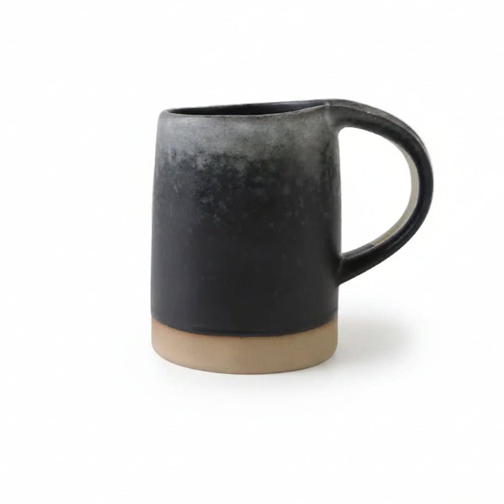 Black ceramic mug with measurements on a white background