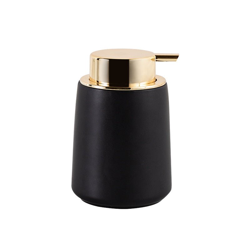 Hand pressing gold pump on matte black stone soap dispenser – TableFab
