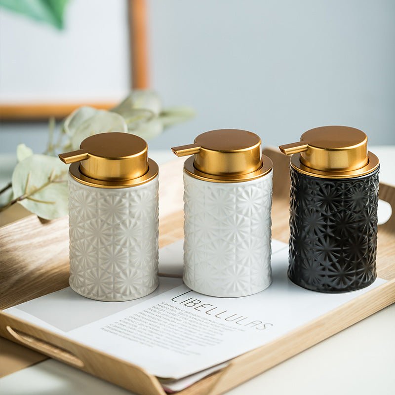 Three decorative jars with gold lids on a wooden tray with a magazine underneath.