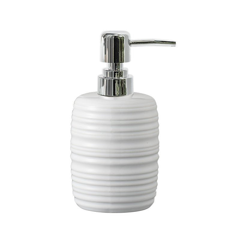White ceramic soap dispenser with a silver pump on a white background