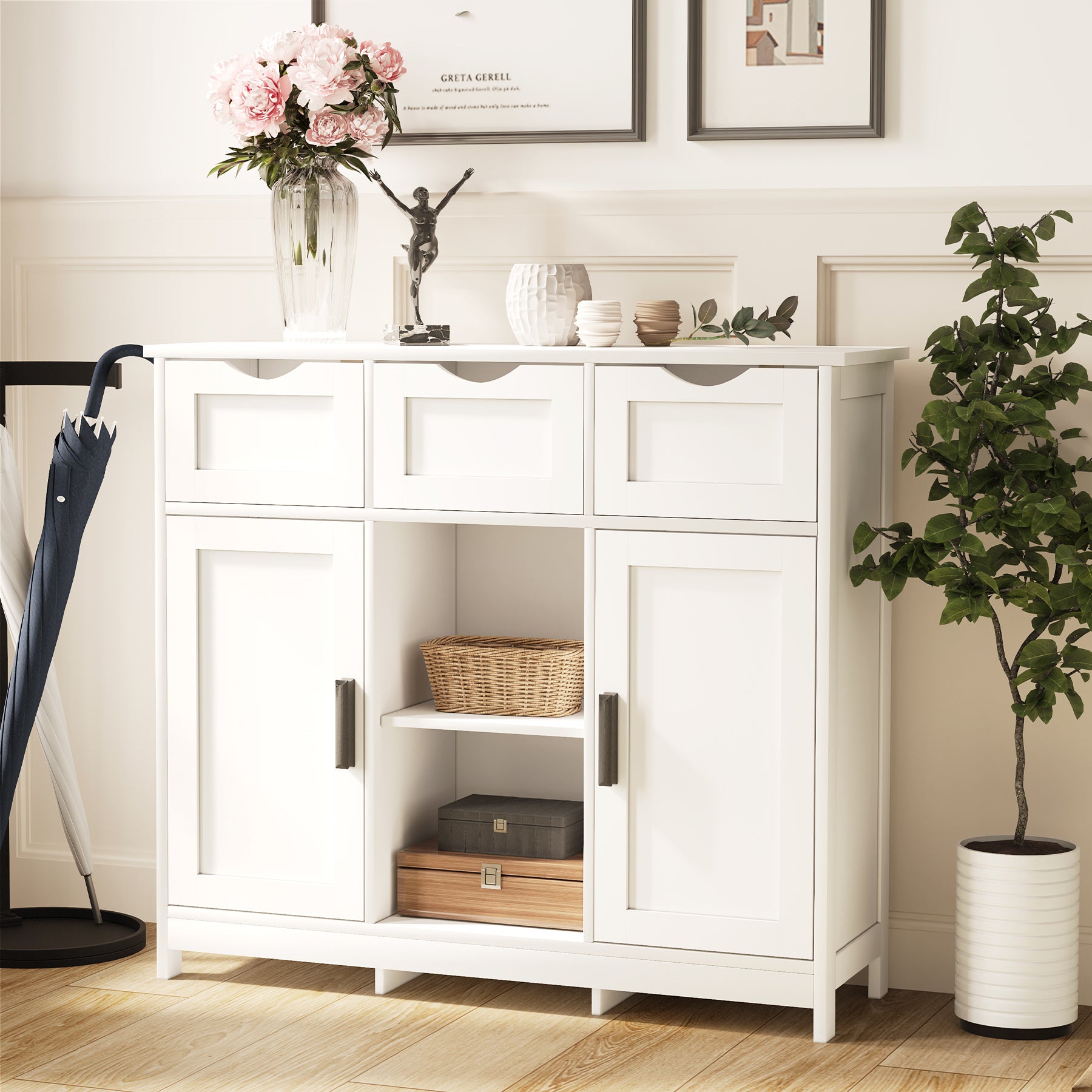 White sideboard with decorative items in a room with a plant and umbrella