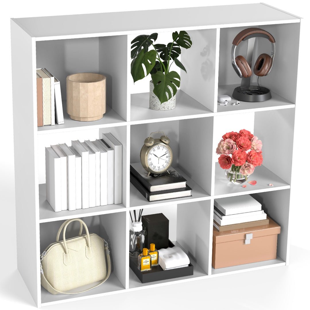 White bookshelf with various items including books, a plant, a clock, and a handbag.