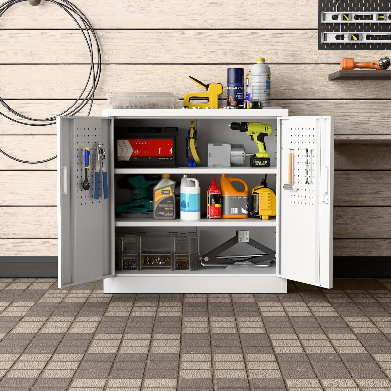 White tool cabinet with open doors displaying various tools and equipment on a wooden floor.