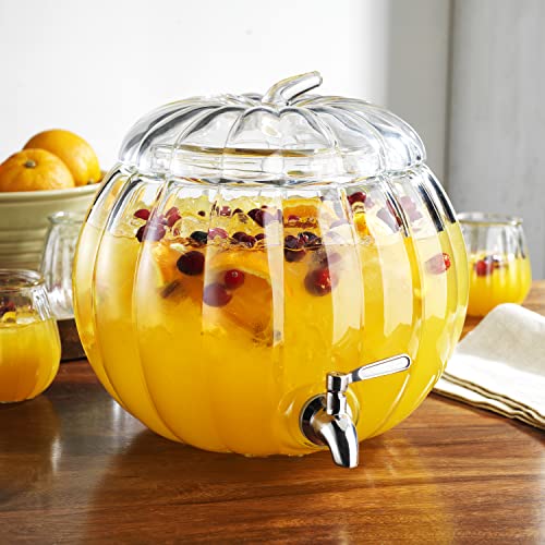 Clear glass pumpkin-shaped beverage dispenser with stainless steel spigot, filled with fruit punch.