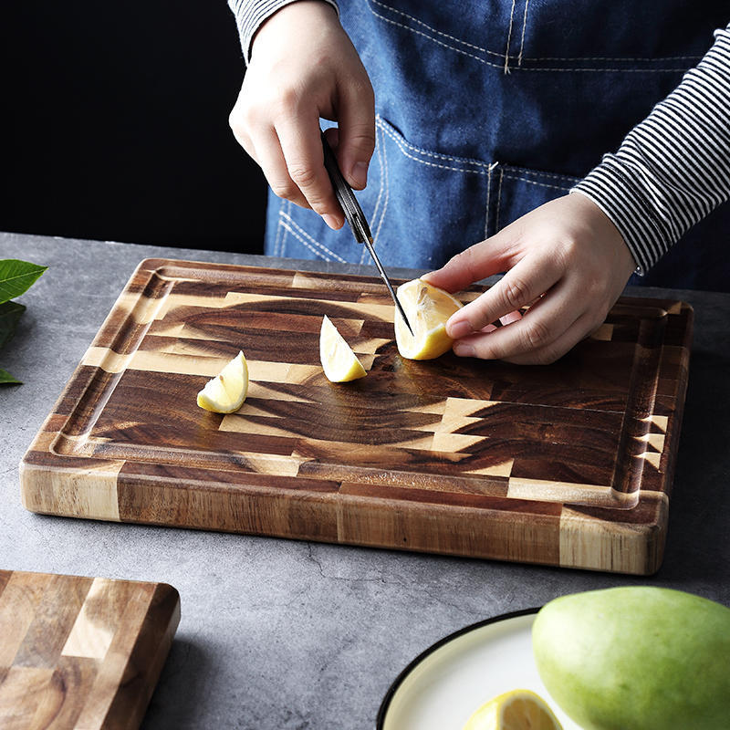 Solid parquet wood cutting board with lemons being sliced, showcasing ample food preparation surface.