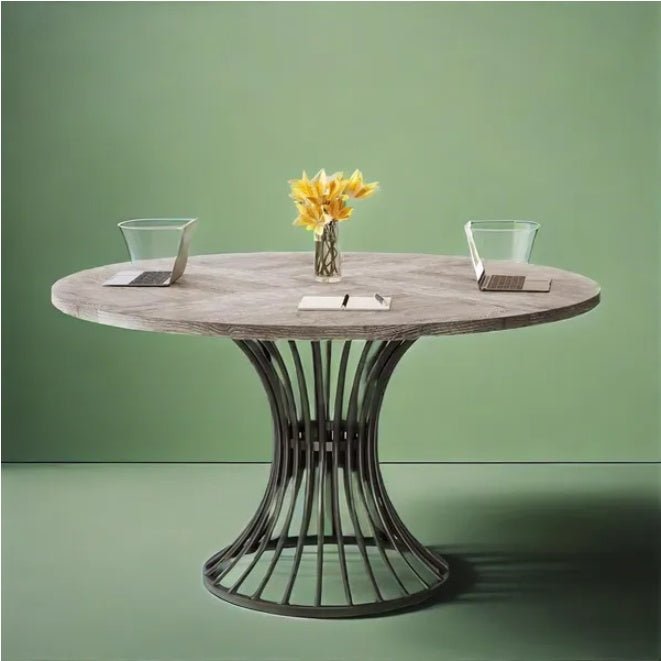 Round wooden table with a metal base against a green background