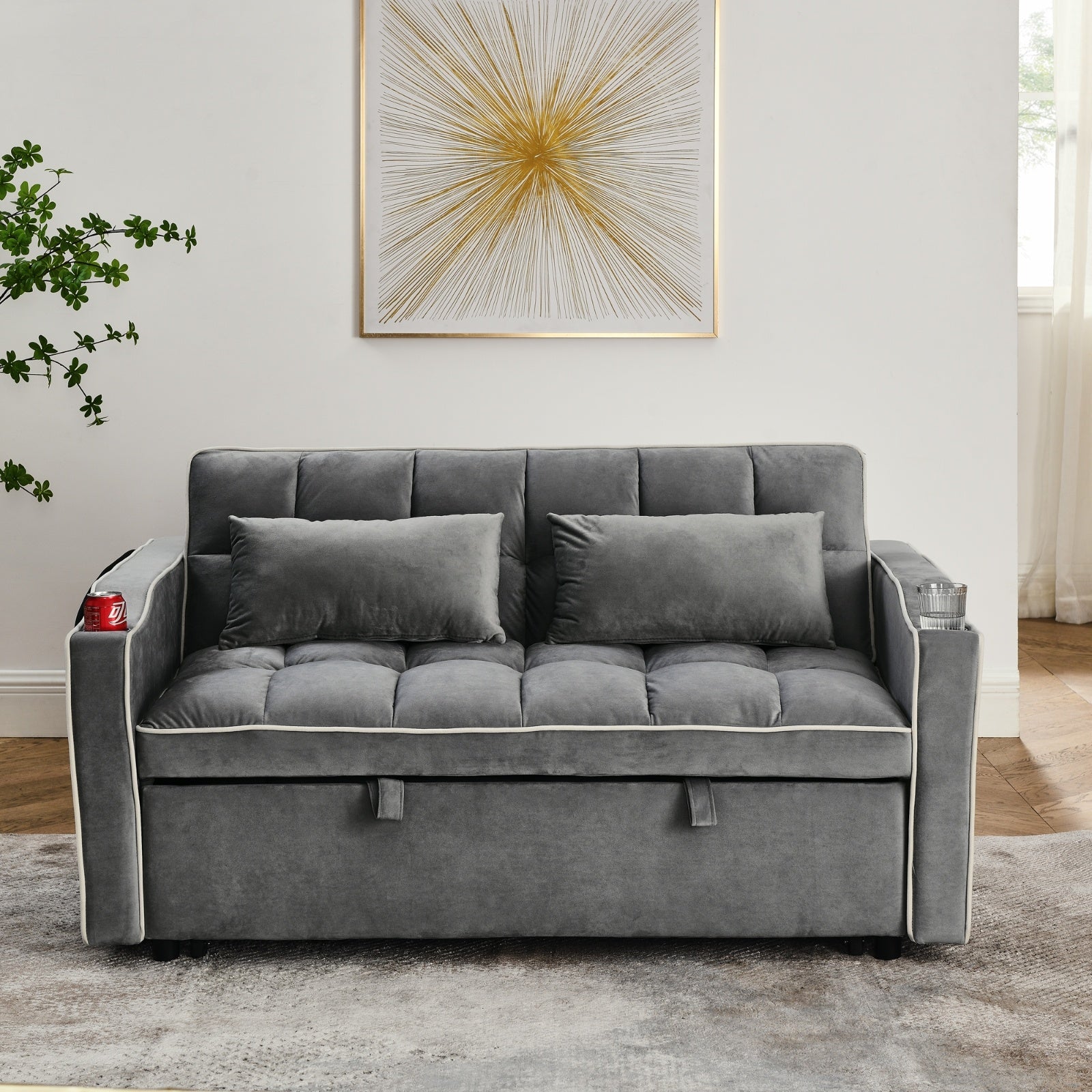 Gray sofa bed in a living room with a decorative painting on the wall.