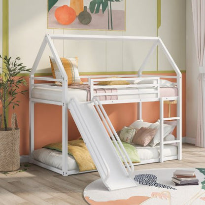 Children's house-shaped bed with slide in a room with orange walls and decorative elements.