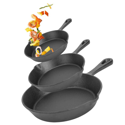 Set of three cast iron skillets on a white background