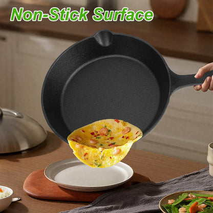 Black cast iron skillet with a cooked omelette on a wooden surface
