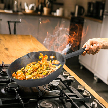 Person cooking stir-fry in a wok on a stove with flames