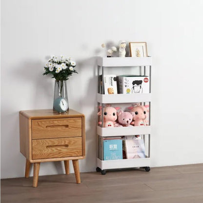 Wooden nightstand with a vase of flowers and a white storage cart with toys and books on a light gray background.