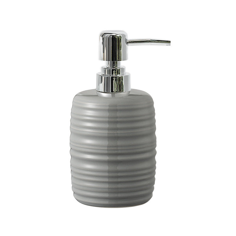 Gray ribbed soap dispenser with chrome pump on a white background