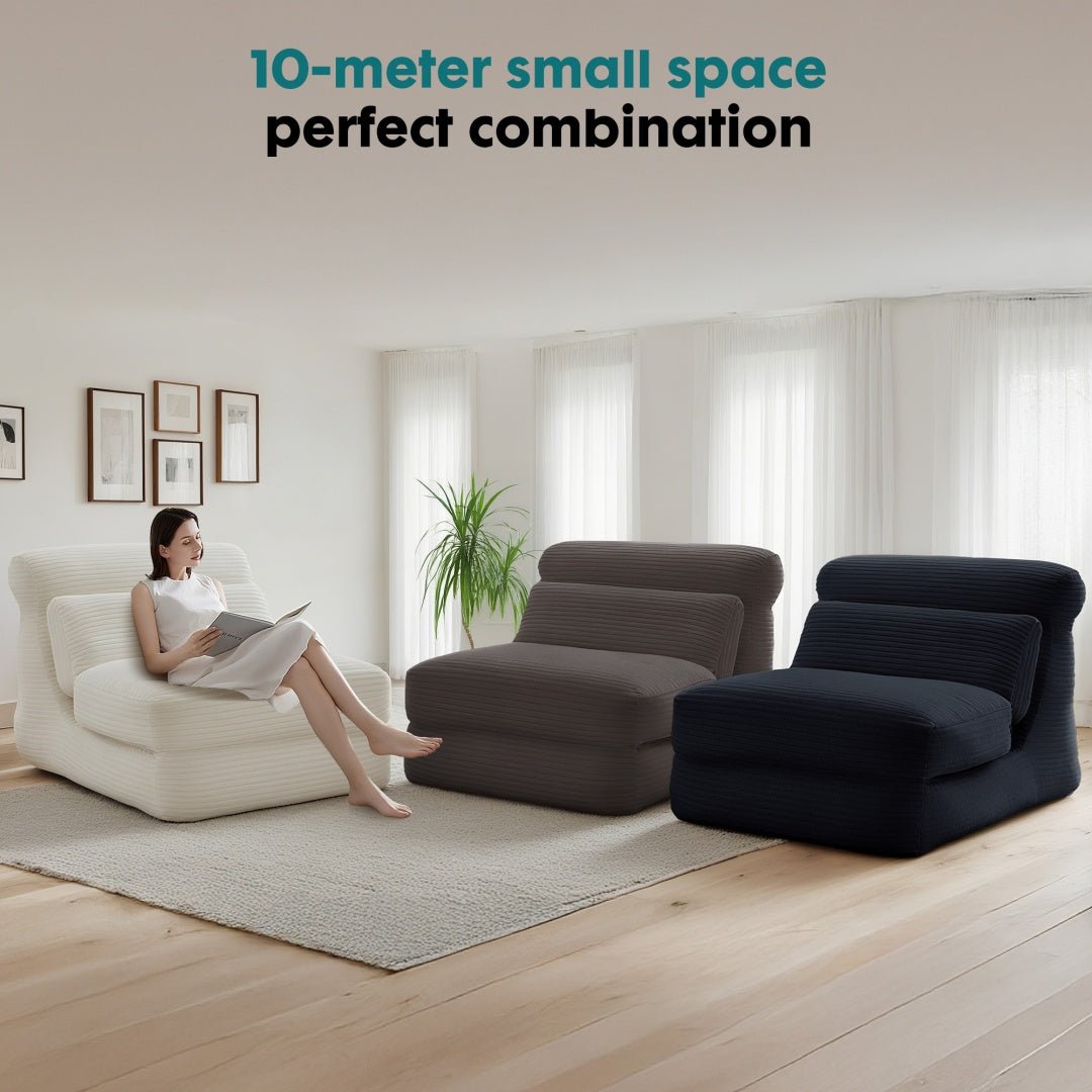 Woman reading a book on a white armchair in a modern living room with three lounge chairs.