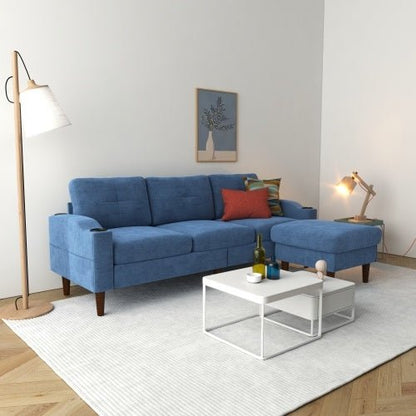 Blue sectional sofa in a living room with a white coffee table and decorative items.