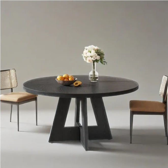 Modern black dining table with chairs and a vase of flowers on a gray background