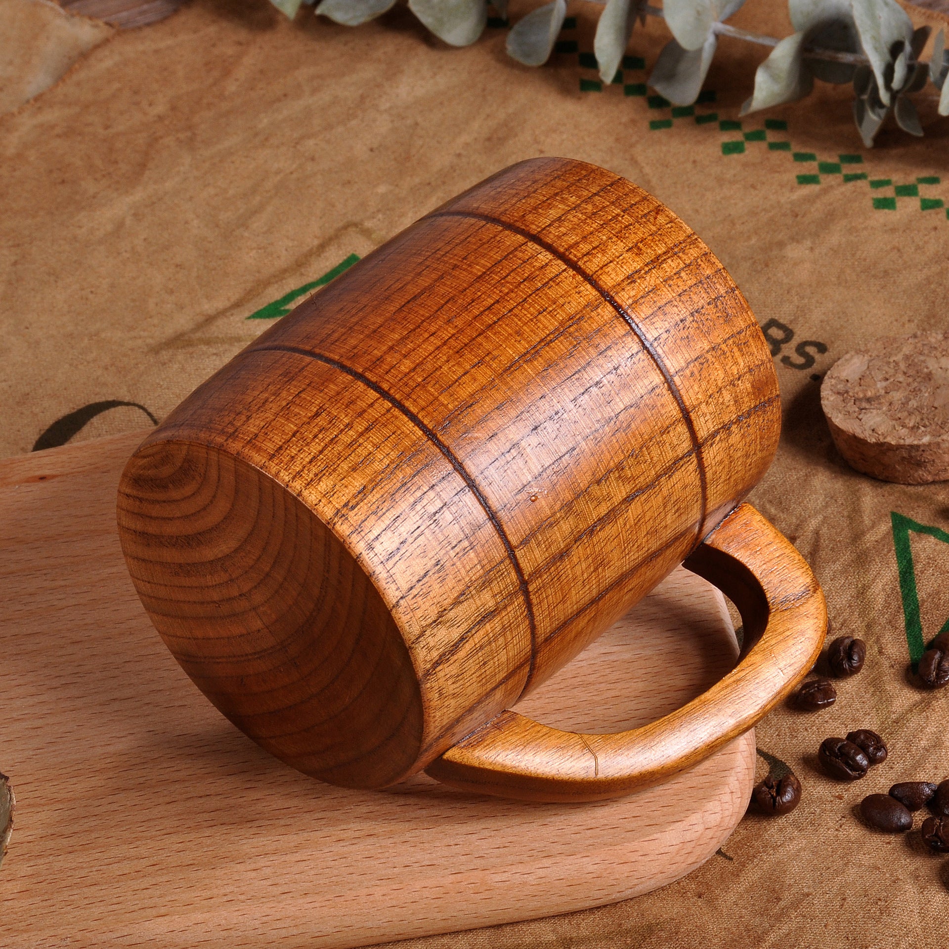 Wooden mug on a rustic background with coffee beans