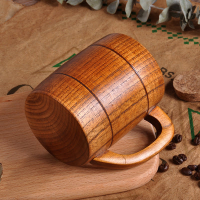 Wooden mug on a rustic background with coffee beans