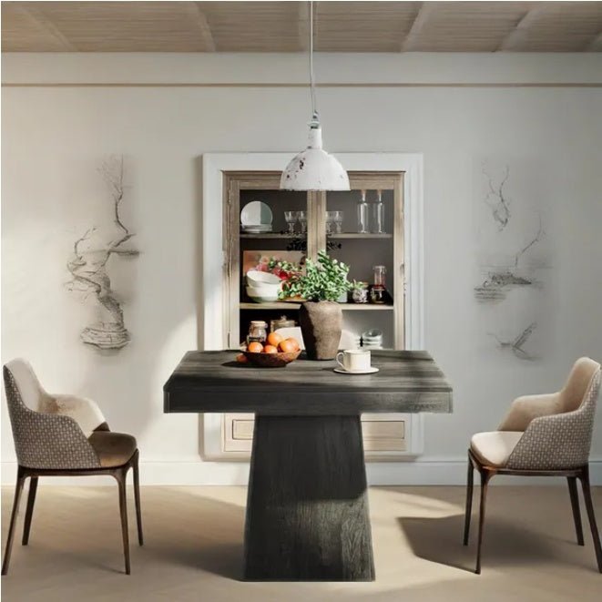 Modern dining room with a dark wooden table and chairs, light-colored walls, and a shelf with decorative items.