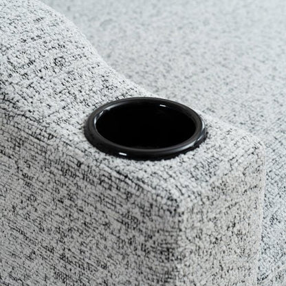 Close-up of a gray textured surface with a black circular object on top