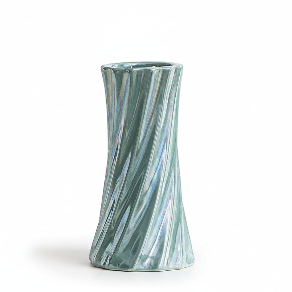A small iridescent ceramic vase with a flared top and twisted, ribbed sides, shown on a clean white surface. Text in the upper left reads 'Diameter 6.