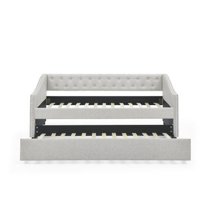 Gray upholstered bed with black metal frame on a white background