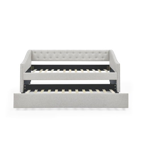 Gray upholstered bed with black metal frame on a white background