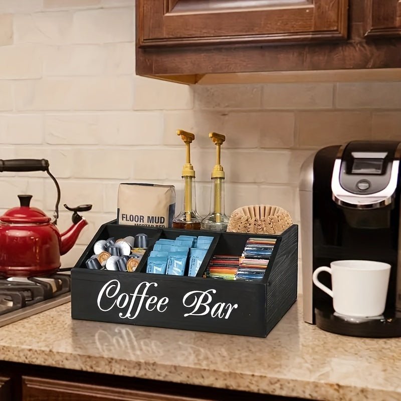 Coffee bar setup with a black organizer, coffee maker, and various coffee products on a kitchen counter.