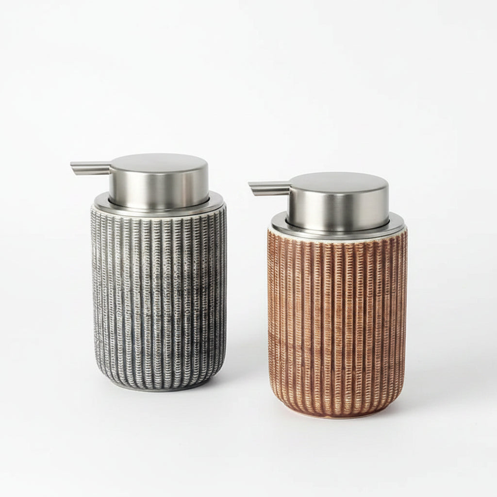 Two decorative bottles with wicker-like texture and metallic caps on a gray surface.