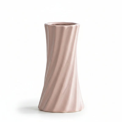 A minimalist, fluted ceramic vase in a soft blush pink color, shown on a clean white surface with a light gray background. Text in the upper left corner displays the product's dimensions: Diameter 6.