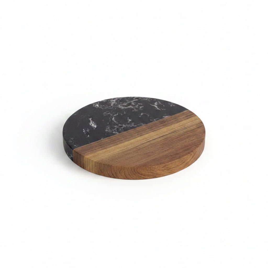 Round cutting board with marble and wood finish on a white background