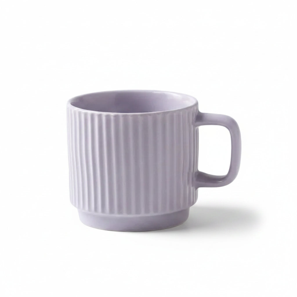 A light purple ceramic mug with vertical fluted ridges and a C-shaped handle, shown on a light surface with text below stating its dimensions and capacity.