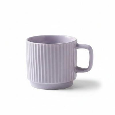 A light purple ceramic mug with vertical fluted ridges and a C-shaped handle, shown on a light surface with text below stating its dimensions and capacity.