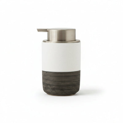 White and black soap dispenser with dimensions on a white background