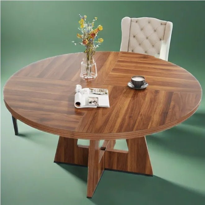 Wooden dining table with a vase of flowers and a cup on a green background