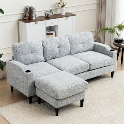 Gray sectional sofa with ottoman in a living room setting.