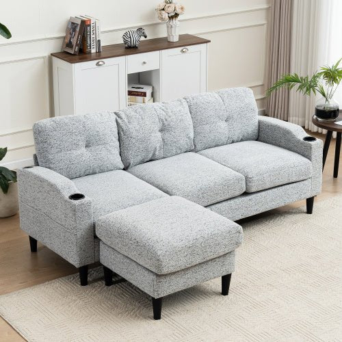 Gray sectional sofa with ottoman in a living room setting.