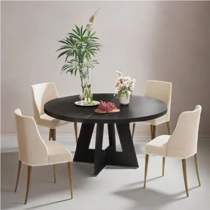 Dining room setup with a black round table and four beige chairs.
