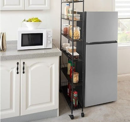Kitchen with a microwave, refrigerator, and a rolling storage cart filled with food items.