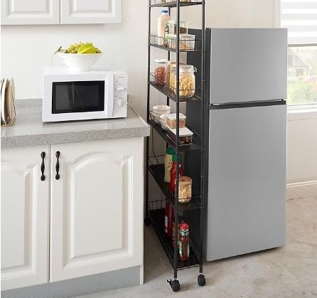Kitchen with a microwave, refrigerator, and a rolling storage cart filled with food items.