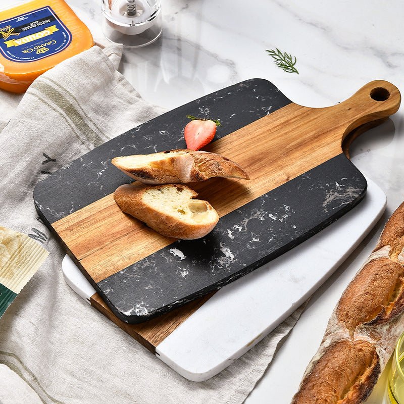 Two cutting boards, one marble and one wooden, with bread slices on a light gray surface.