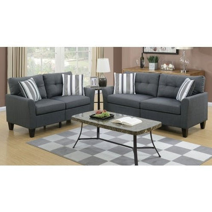 Gray sectional sofa with striped cushions in a living room setting.