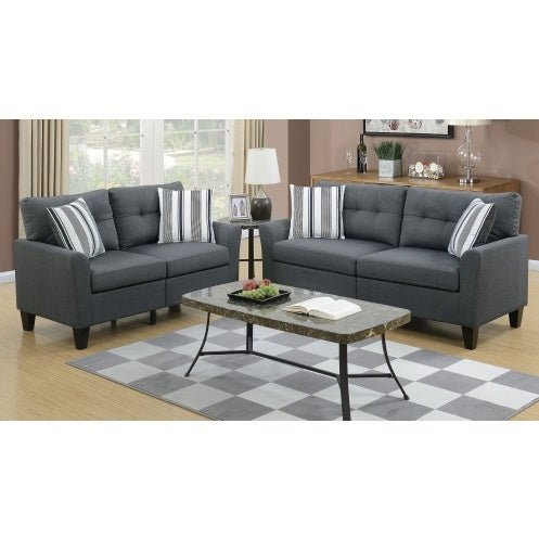 Gray sectional sofa with striped cushions in a living room setting.