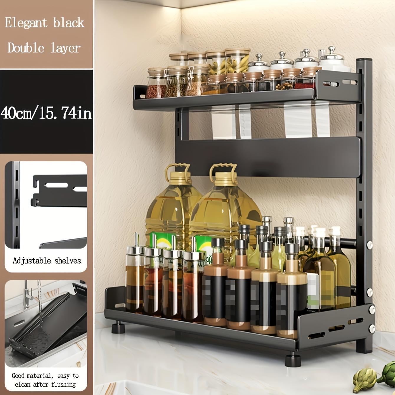 Black double-layer kitchen shelf with jars and bottles on a white countertop.