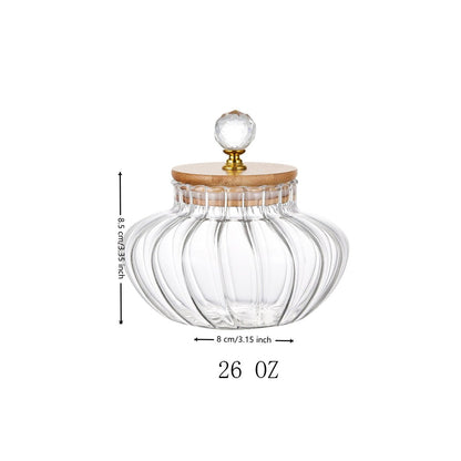 Clear glass jar with wooden lid and crystal knob, featuring measurements and weight on a white background.