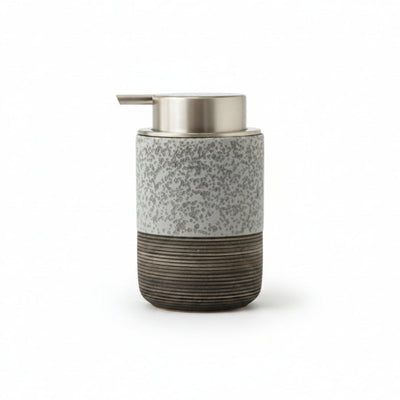 A cylindrical soap dispenser with a speckled gray upper body, a brushed metallic silver pump, and a dark ribbed lower section, shown with dimension labels indicating 8 cm width and 13.5 cm height on a white background.