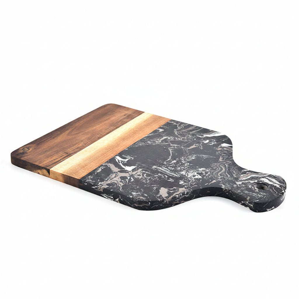 Marble and wood cutting board with a tomato and red pepper on a white background