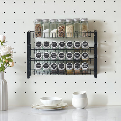 Spice rack with labeled jars on a pegboard wall with decorative elements.
