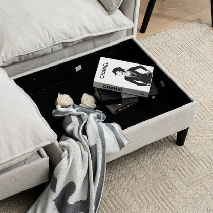 Black coffee table with books and a blanket next to a bed in a bedroom setting